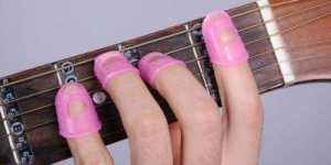 How can  painful fingers be overcame for a guitar beginner?Using finger stall?